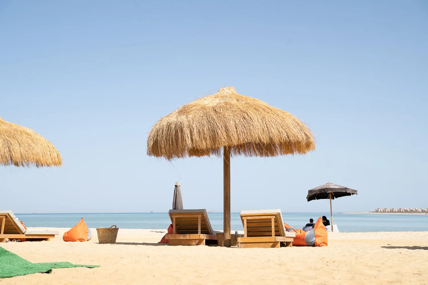 Sandy beach at Fins Sokhna with umbrellas and sun loungers